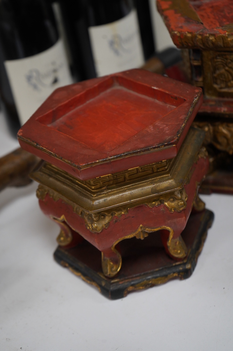 Five Chinese lacquered and partially gilt stands including a hexagonal pair, largest 15cm high. Condition - mostly fair